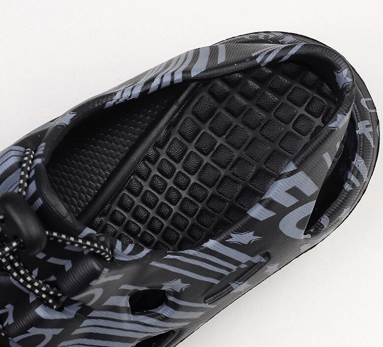 Top view of stylish men's lightweight quick dry clogs with abstract design, perfect for beach or casual wear.